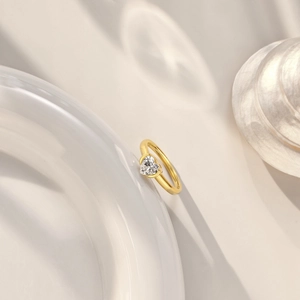 Macro shot of a heart-cut zircon stone set on a polished gold-plated silver ring