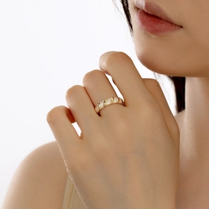 Close-up of golden croissant twist ring with sparkling pave cubic zirconia accents