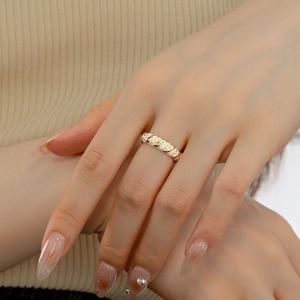 Close-up of a gold twisted S925 silver ring featuring micro-pave zircon on a model's finger