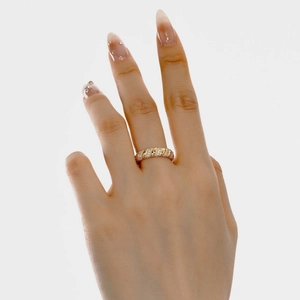 Close-up of gold twisted rope ring with inlaid zircons on a model finger