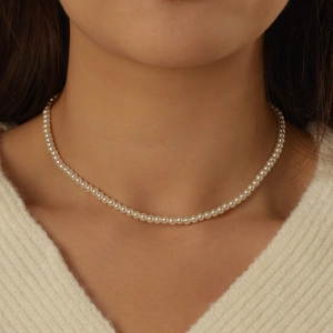 Elegant S925 sterling silver pearl necklace worn by a model on a soft sweater