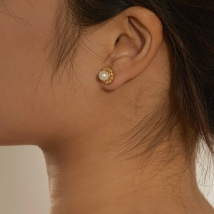 Close-up of elegant S925 silver flower pearl stud earring with pavé zircon accents
