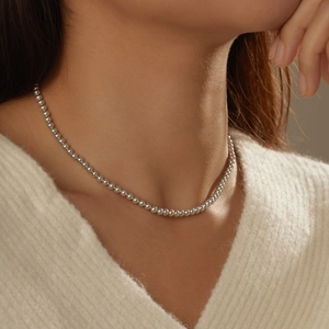 Close-up of elegant S925 sterling silver beaded choker necklace on a female model