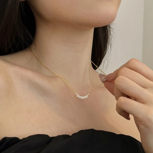 Detail of elegant gold S925 sterling silver bar necklace with pavé cubic zirconia