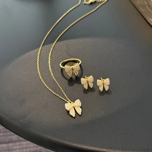 Detail of S925 hallmark on gold butterfly jewelry set including necklace and ring