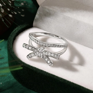 Detail of S925 silver bow ring with zircon pavé set in a green velvet Christmas gift box