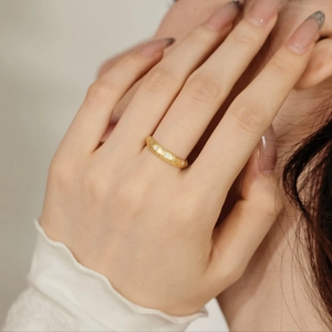 Close-up of elegant gold star ring with zircon inlay worn on index finger of a model
