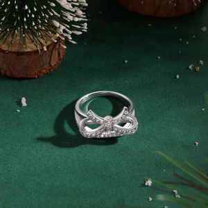 Detailed view of silver bow-shaped S925 sterling silver ring with shimmering cubic zirconia