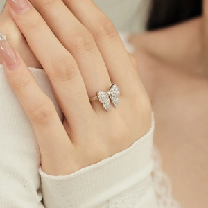 Detail of s925 silver butterfly ring featuring sparkling zircon stones on a model hand