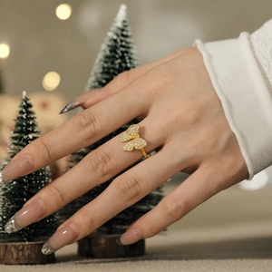 Detailed view of an adjustable gold butterfly ring with sparkling cubic zirconia pavé