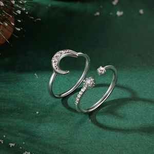 Nahaufnahme der S925 Sterling Silber Mond und Stern Ringe mit Zirkon auf grünem Hintergrund