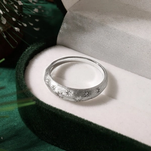 Detailed close-up of S925 sterling silver star ring with zircons in a green gift box
