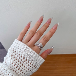 Detailed view of S925 silver crown ring with pear-cut cubic zirconia on a model's finger