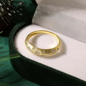 Macro shot of S925 silver star ring with gold frosted finish and white zircon in velvet box