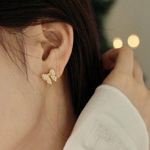 Close-up of elegant S925 silver butterfly stud earrings with sparkling cubic zirconia