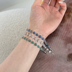 Detail of S925 silver four-leaf clover bracelets with emerald, sapphire and white zircon
