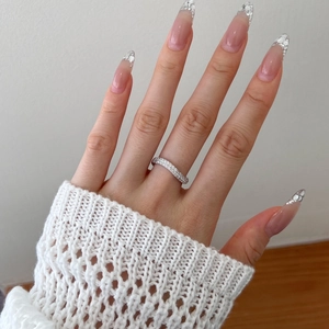 Close-up of S925 sterling silver wavy ring with double row zircon inlay on finger