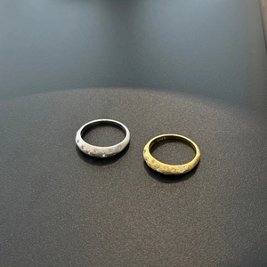 Detail of S925 sterling silver and gold starburst rings with inlaid cubic zirconia