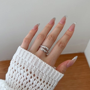 Detailed view of S925 sterling silver snake texture ring with sparkling zircons worn on finger