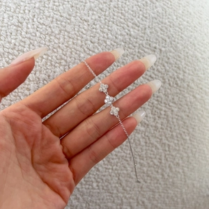 Detailed close-up of S925 silver clover bracelet with sparkling cubic zirconia settings