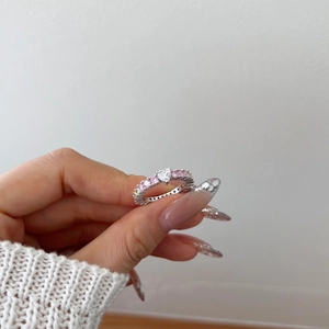 Detail of S925 sterling silver ring with heart-shaped pink zircon and crystal stones