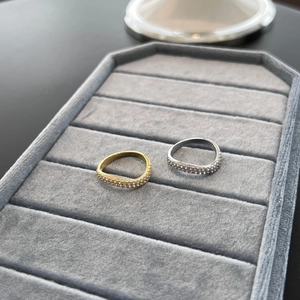 Double row zircon S925 silver wave rings in gold and silver finish shown on velvet