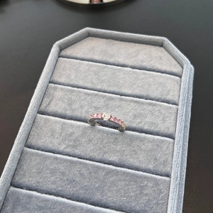 S925 sterling silver heart ring with rainbow gemstones on a blue velvet display