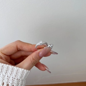 Elegant S925 sterling silver ring with square cut center diamond on a woman's hand