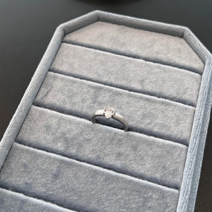Macro view of pear cut zircon silver ring with brushed matte texture on blue velvet