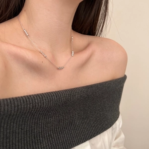 Close-up of S925 sterling silver necklace with beads worn by a model for a daily look