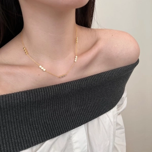 Close-up of elegant S925 silver necklace with gold plating and sparkling zircon on neck