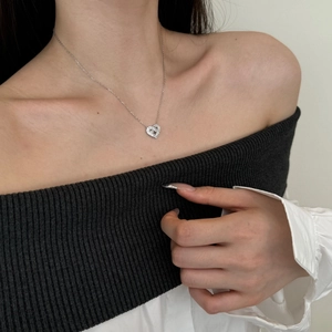 Detail view of double heart pendant necklace featuring micro-pave set sparkling cubic zirconia