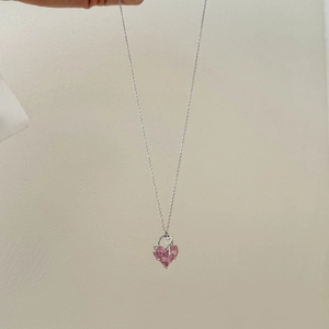 Detail of S925 silver necklace featuring a pink heart-shaped gemstone and key pendant