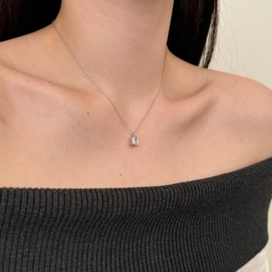 Close-up of S925 silver necklace with ice-flower cut square zircon on a model's collarbone