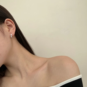 Detailed close-up of S925 sterling silver stud earring with zircon inlay on model