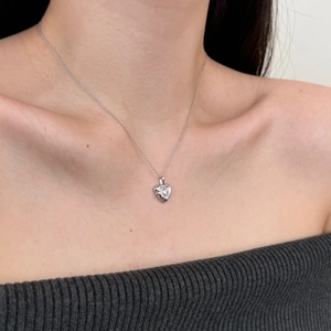 Elegant S925 sterling silver heart necklace with zircon pendant worn on a collarbone
