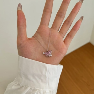 Dettaglio del ciondolo a forma di cuore rosa con anello di Saturno su catena in argento