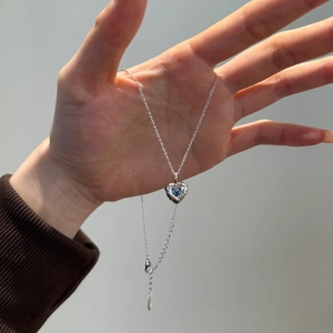 Elegant S925 silver necklace featuring a blue heart gemstone pendant with water wave design