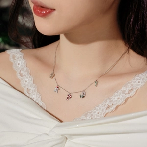 Macro shot of S925 silver HAPPY Christmas necklace with festive holiday charms