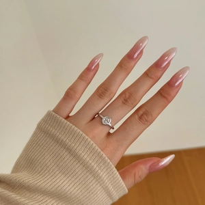 Detailed view of an oval-cut clear zircon S925 sterling silver ring worn on finger