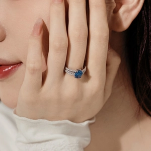 Close-up of S925 silver ring featuring a blue oval gemstone and double row of diamonds