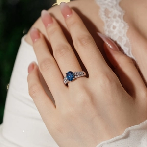 Elegant S925 sterling silver ring featuring a blue oval gemstone and sparkling zircon rows
