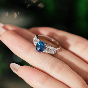 Elegant S925 silver ring with oval blue zircon stone and pavé-set side diamonds