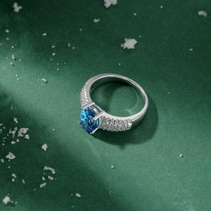 Macro shot of S925 silver ring featuring blue oval gemstone and diamond pavé band