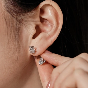 Close-up of S925 sterling silver reindeer bow and round zircon stud earrings set for women
