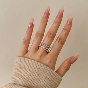 Close-up of S925 silver stacked rings with marquise-cut zircon on a model's hand
