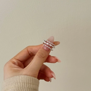 Close-up of three S925 silver rings with marquise and round zircon pavé on model's hand