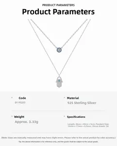 Detail of S925 sterling silver Hamsa hand necklace with blue devil eye pendant and zircons