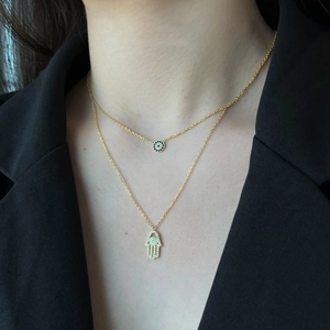 Close-up of double-layer S925 silver necklace with Hamsa hand and Evil Eye pendants