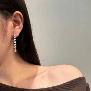 Detailed view of S925 sterling silver tassel earrings with marquise cubic zirconia on ear